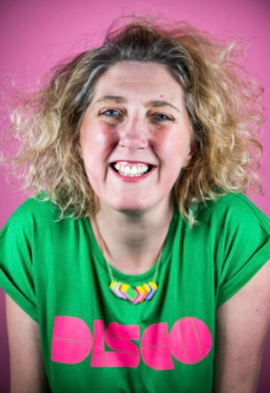 Tracey Davies laughing, in a DISCO t-shirt