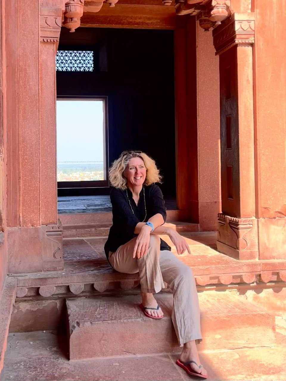 Tracey Davies in a red-sandstone Mughal doorway in India